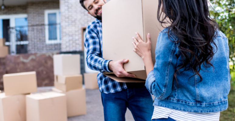 new homeowners moving boxes into home