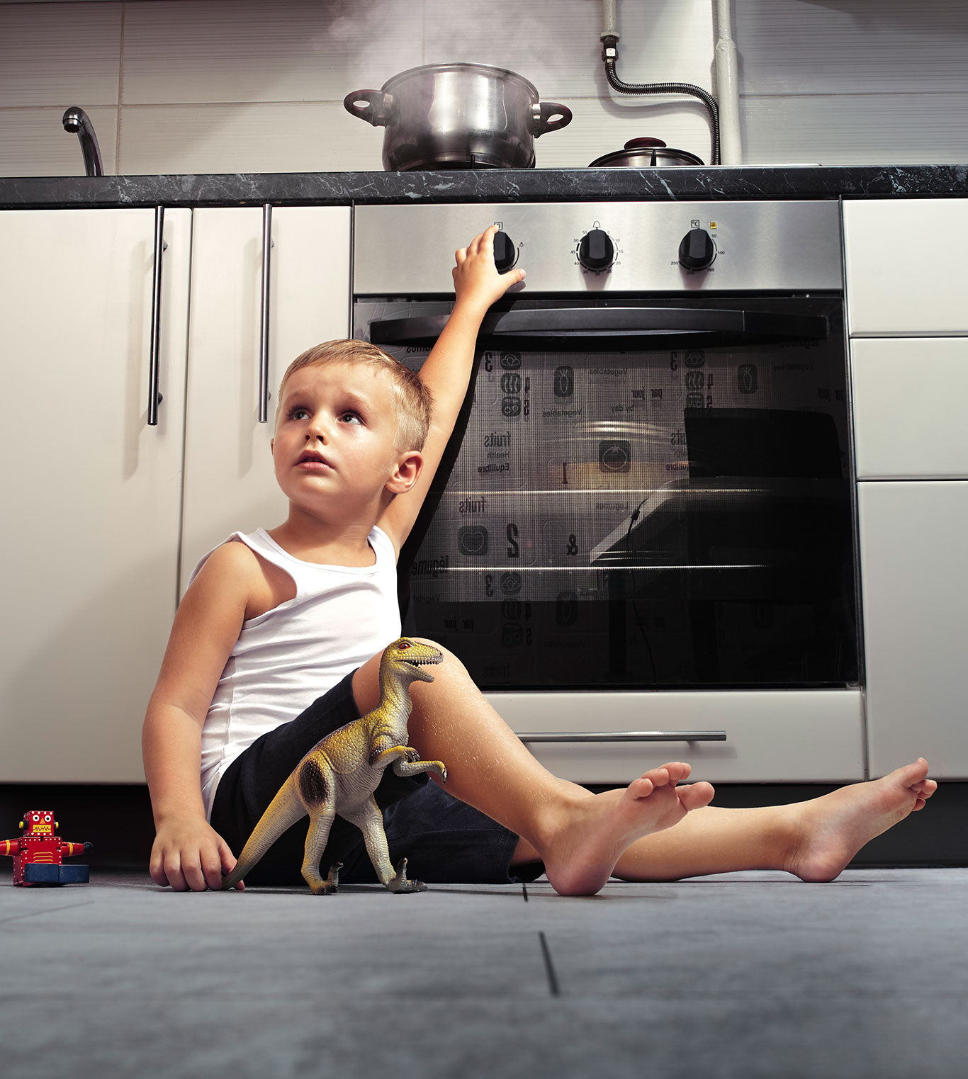 boy touching hot stove