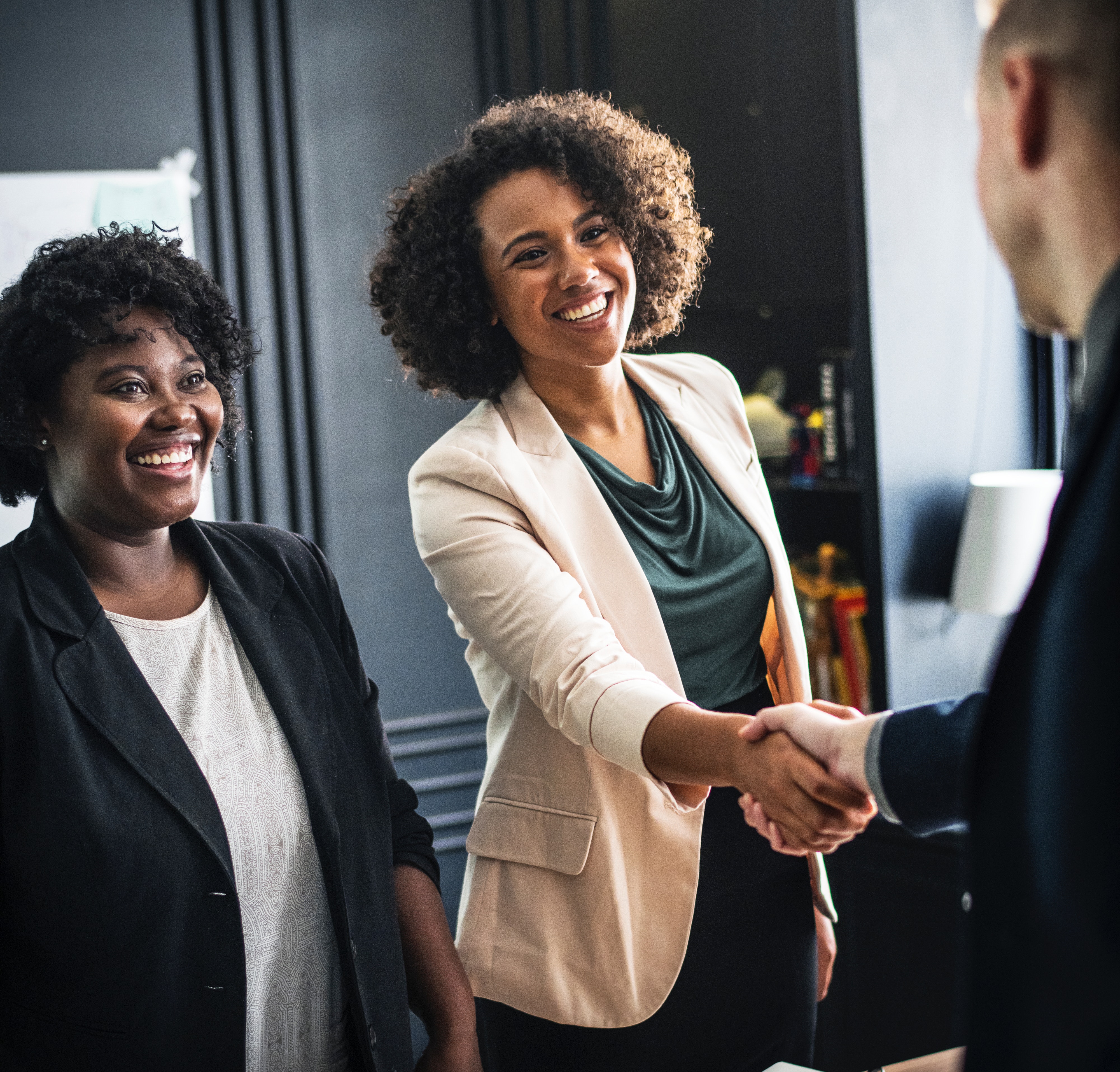 female office manager shaking hands with colleague in st louis office