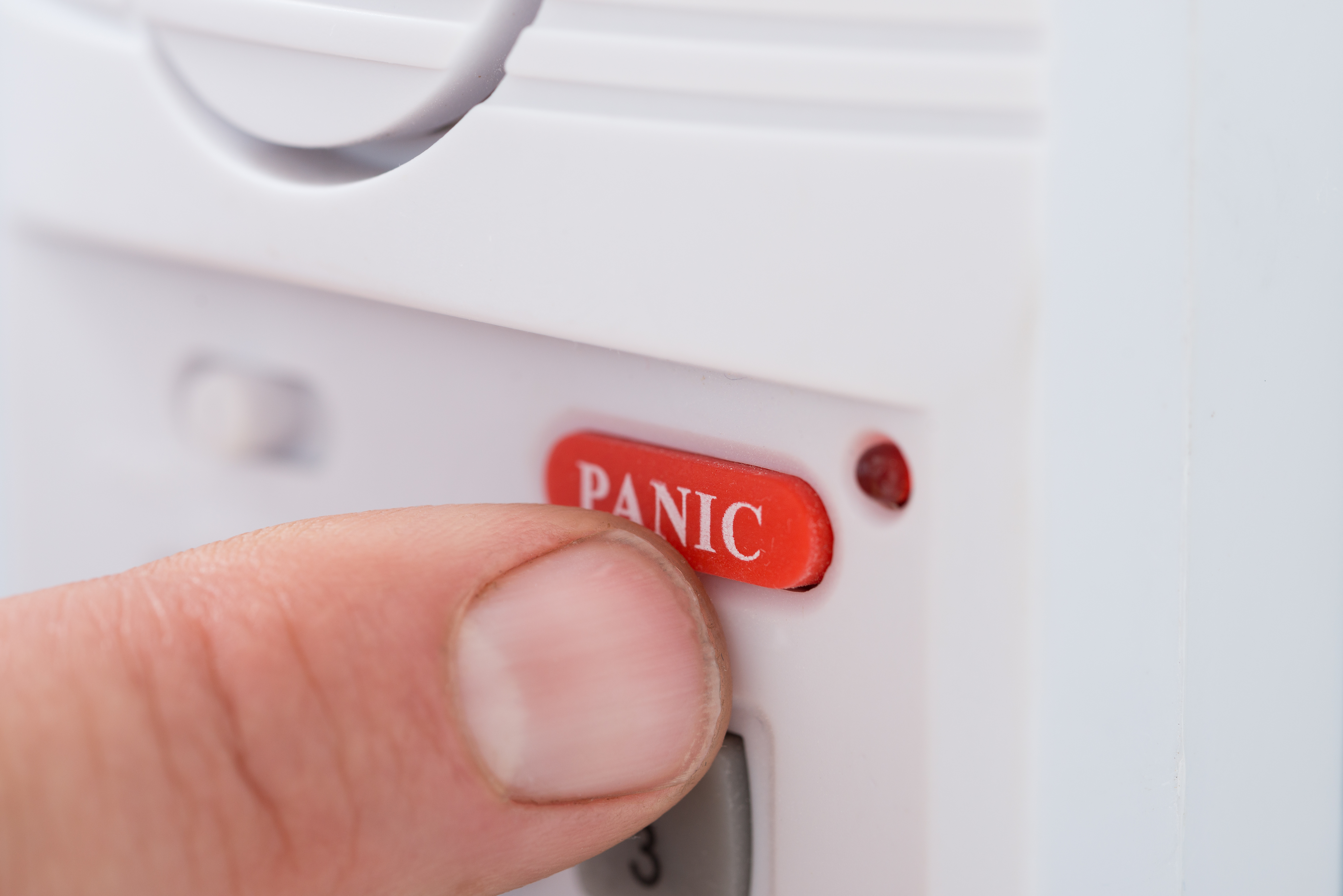 person pushing a panic duress alarm button to call for emergency help