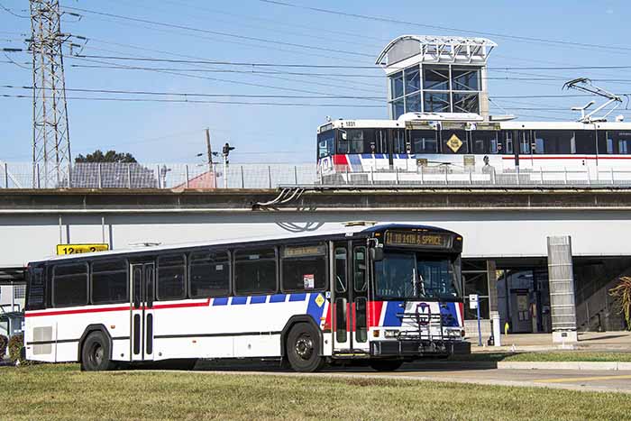 St. Louis Metrolink commuter passenger train and metro transit bus leaving