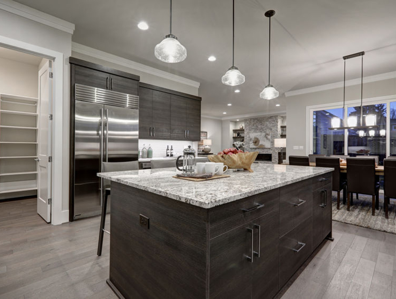 Modern gray kitchen features dark gray cabinetry