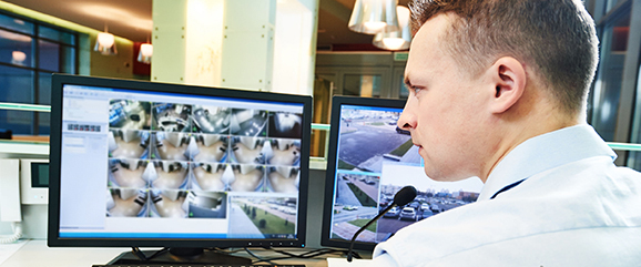 security guard monitoring video screen