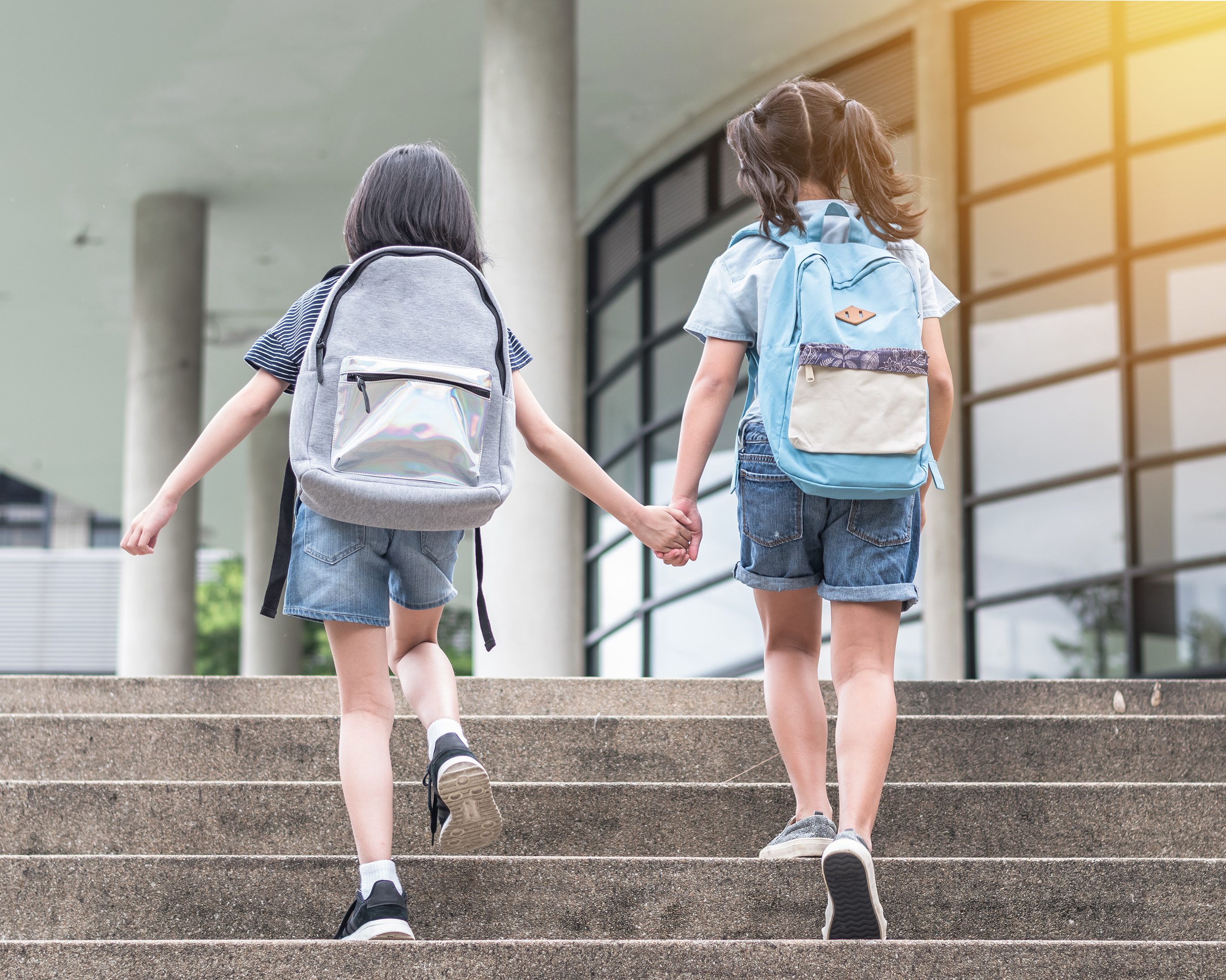 two young female students walking to school