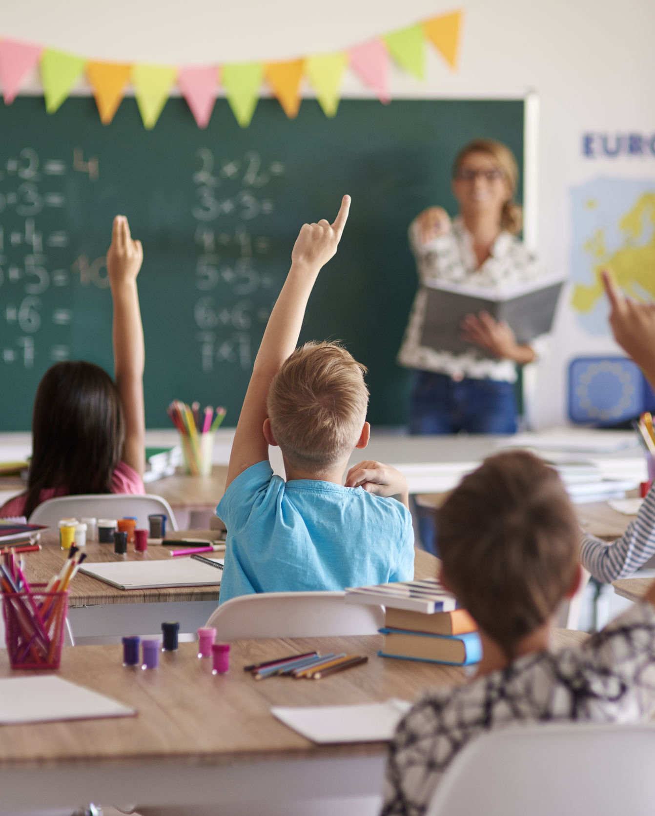 k-12 Grade School Students Raising Their Hands in Classroom