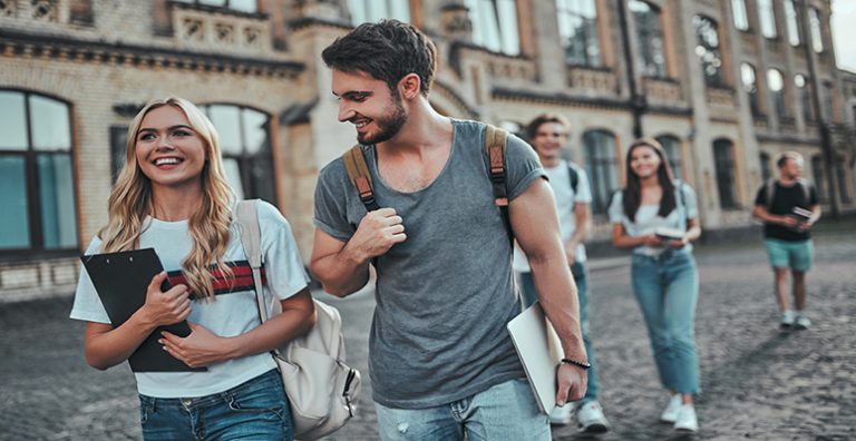 College Students Walking On University Campus Protected By Security Surveillance Cameras