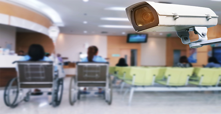 security camera inside hospital lobby with people in wheelchairs