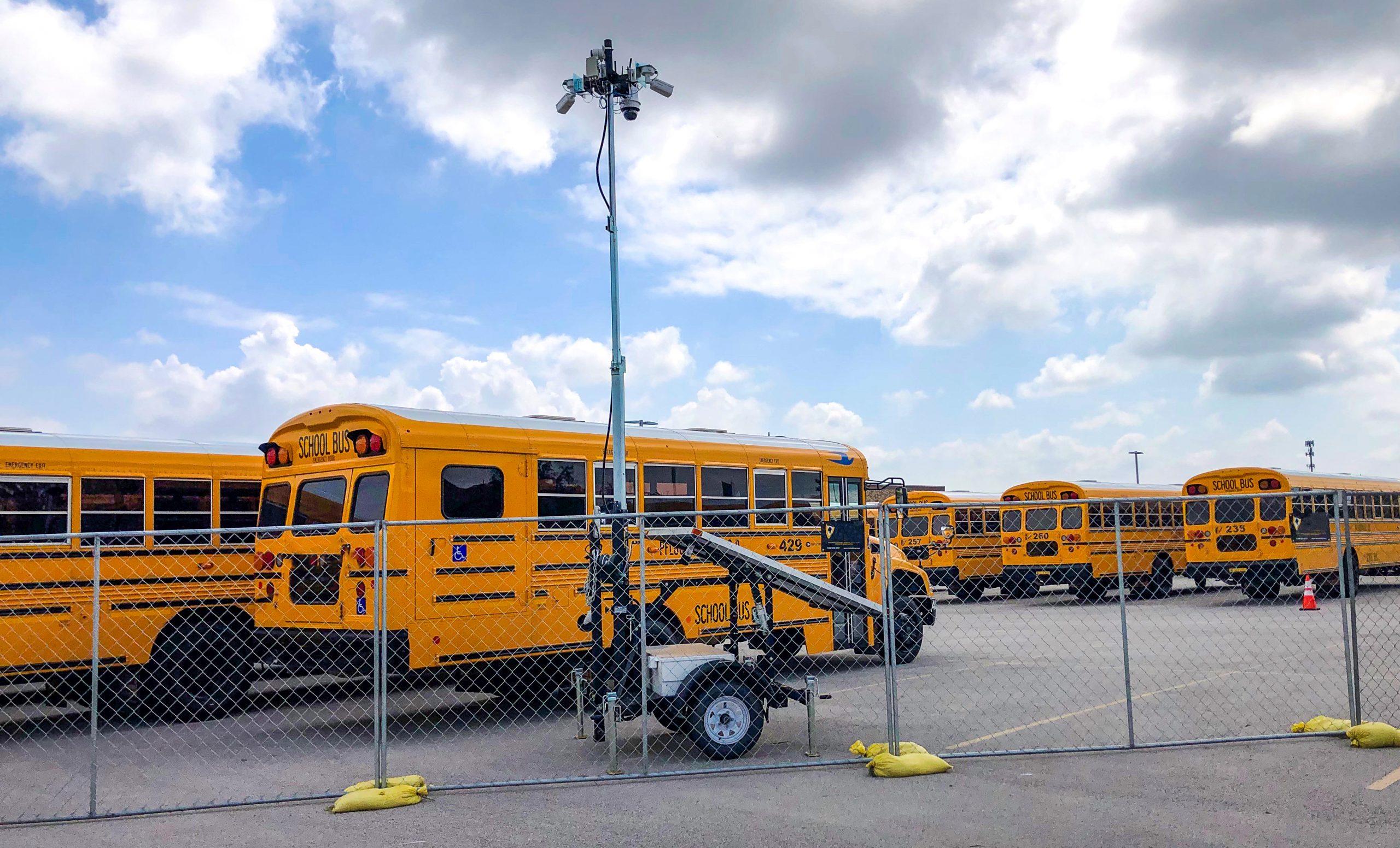 solar powered security camera trailer in school bus parking lot