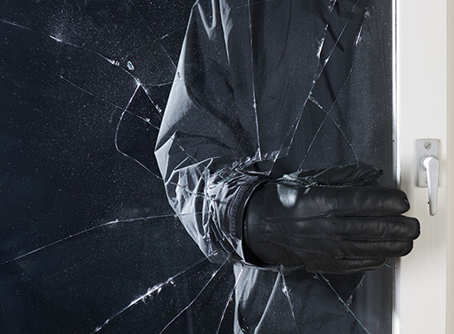 Burglar Breaking Glass Window at Business