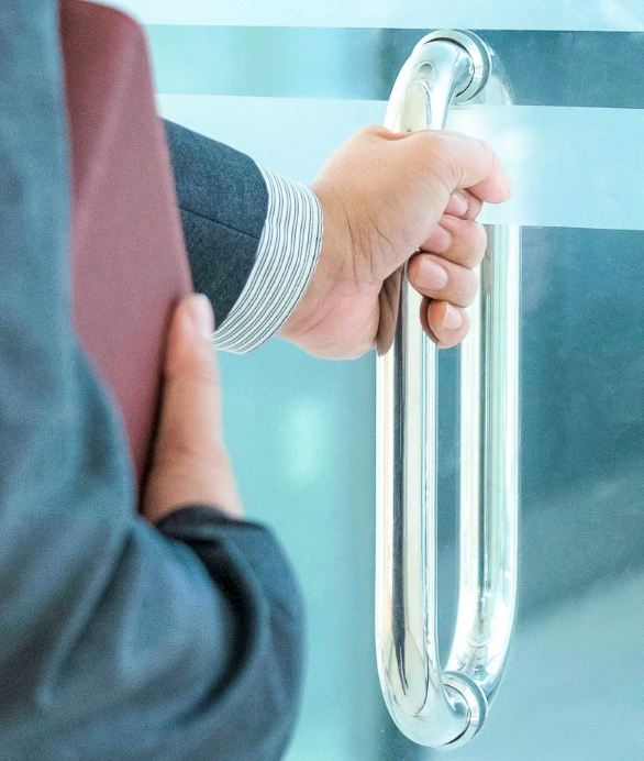 Businessman Opening Glass Office Door