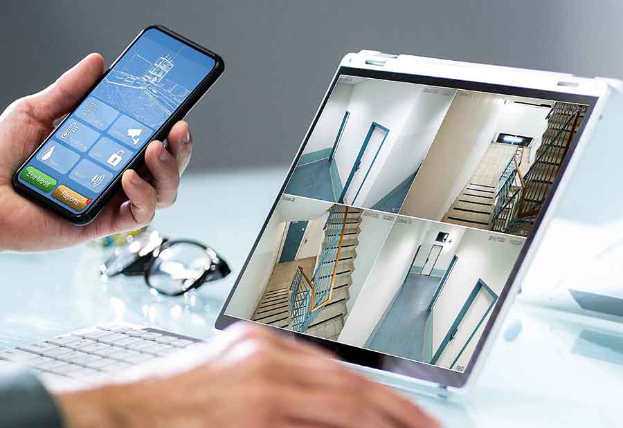 Business Owner Viewing Surveillance Security Cameras on Cell Phone and Tablet