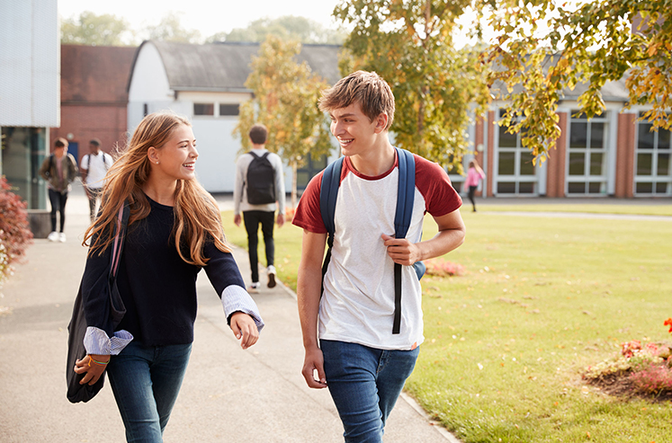 Teenage Students Walking on College Campus in st louis missouri protected by surveillance security cameras