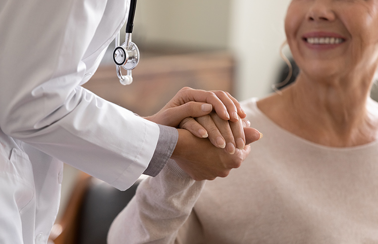 hospital doctor holding patients hand